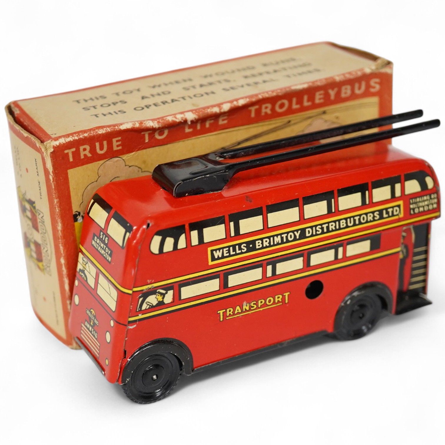 A boxed Wells Brimtoy tinplate clockwork trolley bus loosely in London Transport livery, together with three keys. Condition fair to good, clockwork motor appears to work correctly although has lost grip on the driving a